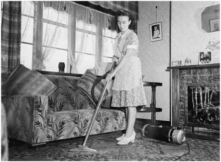 Evans Family Collection: Mrs Evans vacuuming the living room, 5 Mansford Place