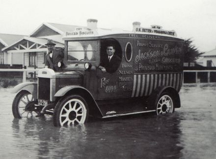 Grocery truck driving through flood waters on Armstrong Street