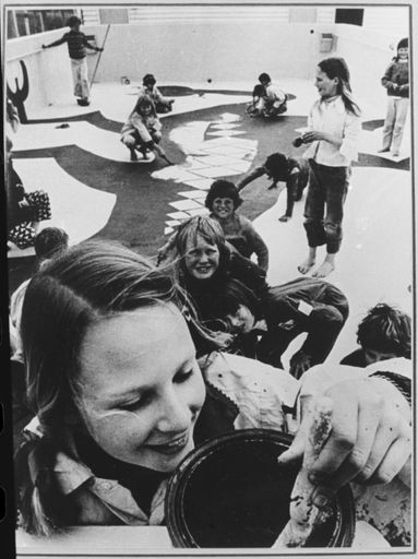 Pupils painting the taniwha inside the school pool at Fitzherbert East School