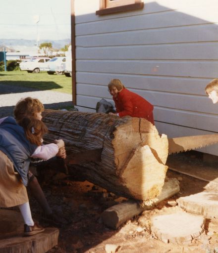 School pupils sawing wood at the museum at Palmerston North