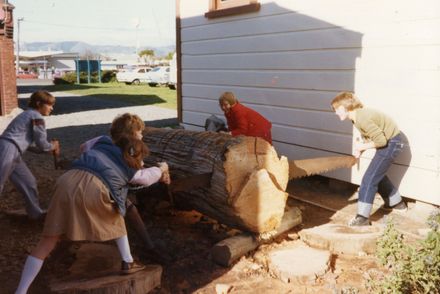 School pupils sawing wood at the museum at Palmerston North