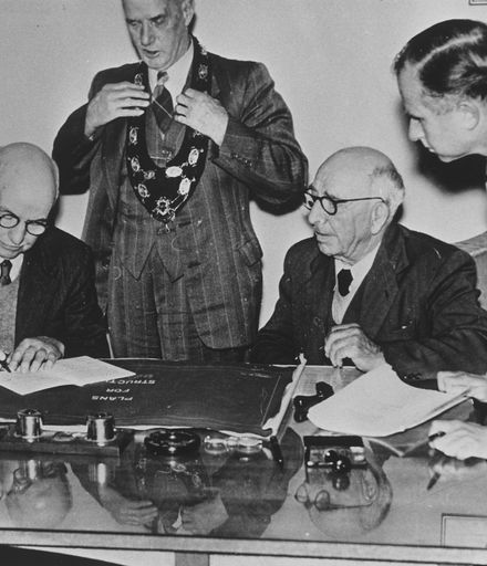 Arthur Hopwood signing Clock Tower contract documents