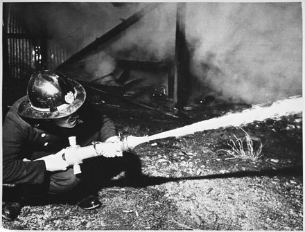 Fireman fighting fire at Television Installation and Service Company Ltd, Grey Street