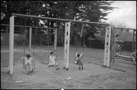 Children enjoying the playground swings