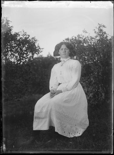 Young Woman Seated Amongst Trees