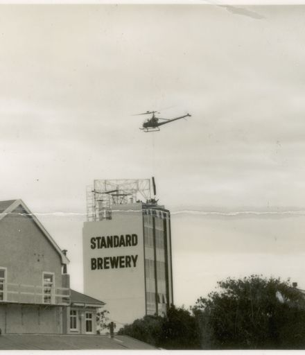Helicopter Used in Installation of Standard Brewery Sign
