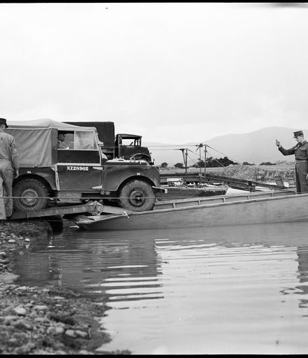 "Versatile Engineers Show Their Paces" - Army Engineers Loading Landrover onto Raft