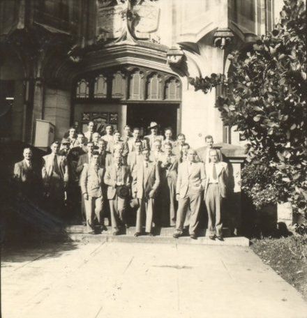 Group of men (26) on steps of University building ?