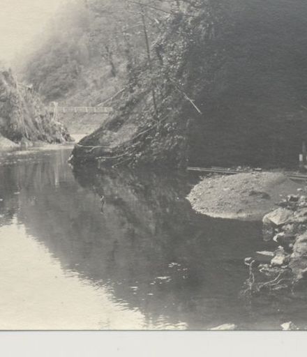 River gorge with wire bridge in distance