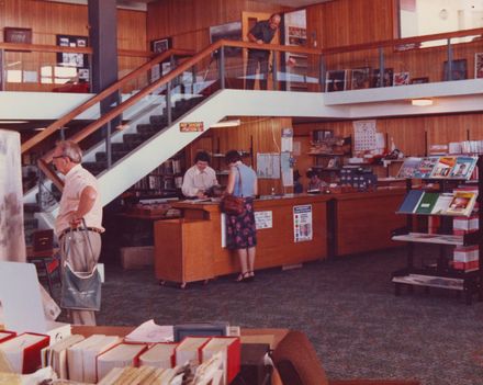 Interior of Levin Library showing issues desk beside main stairs to mezzanine, 1981