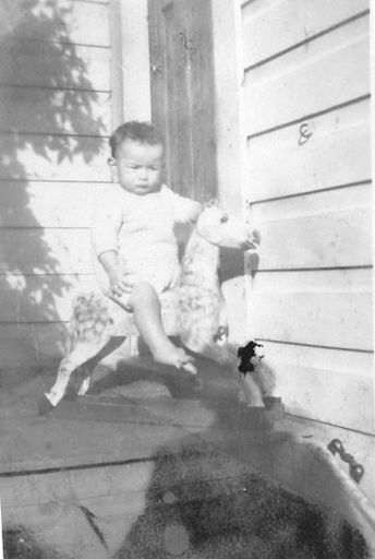 A child on a rocking horse.