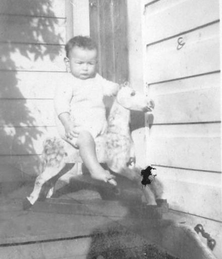 A child on a rocking horse.