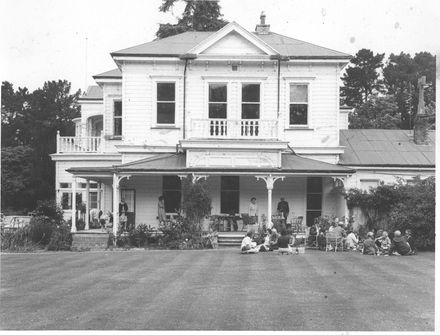 Side view of 2-storey house showing family gathering ?