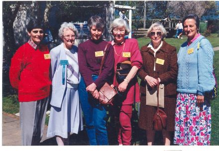 Group of female ex staff looking around the school grounds