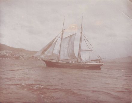 Unidentified 2-masted sailing ship, sailing in harbour