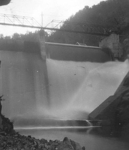 View from downstream showing water spilling over dam, Mangahao, 1936