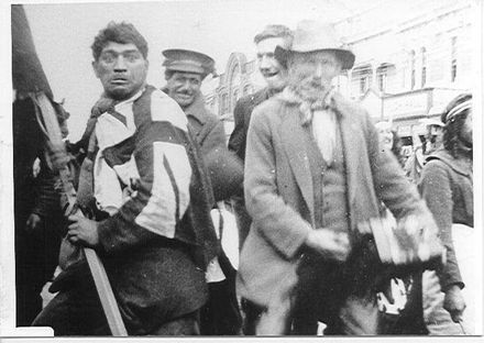 Group of four unidentified people in an Oxford St parade