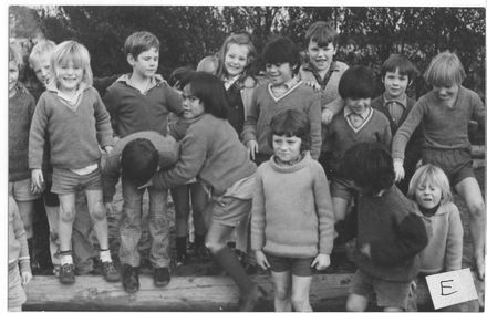 Children grouped in sand pit in playground