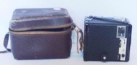Brownie camera in brown leather case.