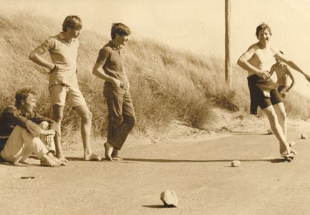 Boys skateboarding on tar-seal at unnamed beach, 1969 - Resource cover image