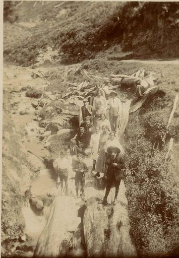 Group standing on log, Heights Road, Christmas Day, 1913