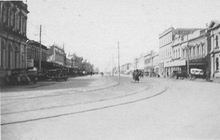 Main street with double tram-lines in unidentified city, 1927 or 1928