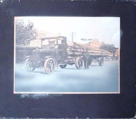 Thornycroft truck with load of wooden power poles, c.1923