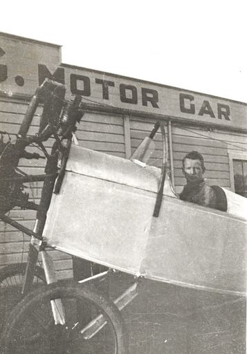 Jack Butler sitting in plane at garage