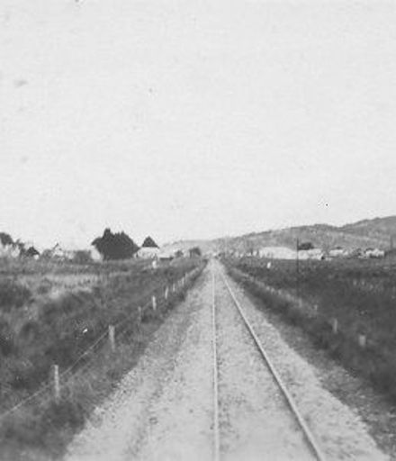 View from rear of train after leaving an unidentified rural town, 1927 or 1928