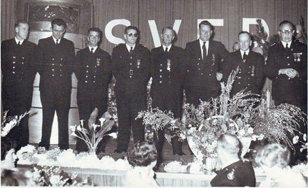 Eight men in brigade dress uniform on stage during function, 1950's (?)