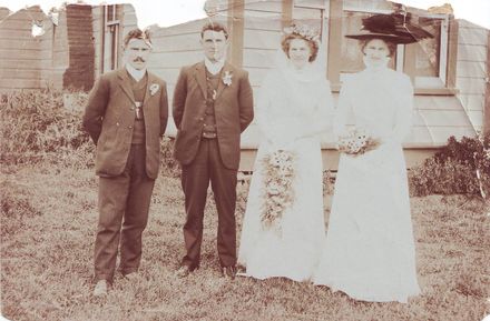 Unidentified wedding group outside house