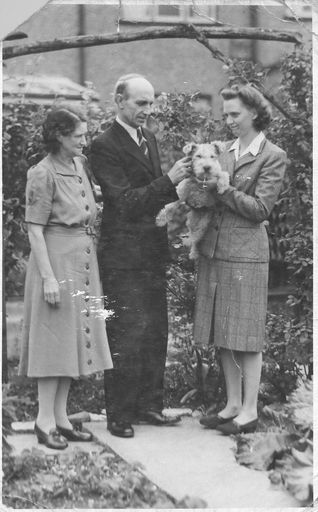 A man, two ladies and a dog. - Resource cover image