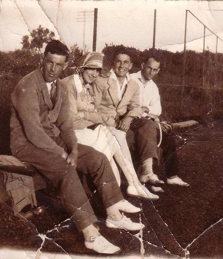 Group of four people at tennis courts, 1925-30