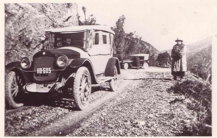 Cars and people on road at Mangahao, 1922