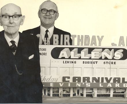 Mr A.W. Allen (founder) & son "Jack" with model of firm's store