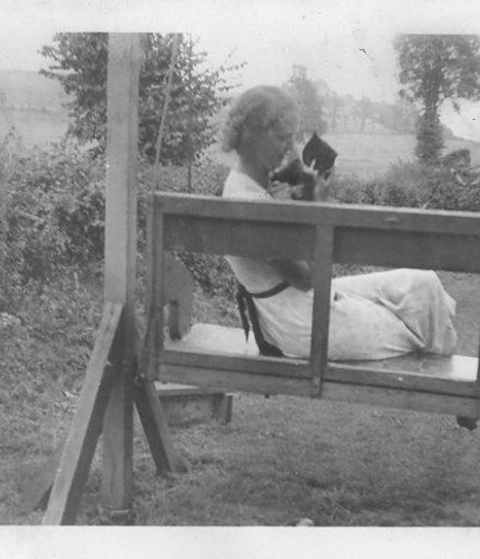 Young woman on swingseat with cat at Babbacombe 1938