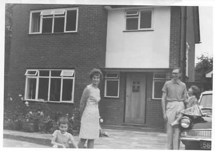 Couple with 2 children outside house. - Resource cover image