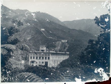 View of Mangaore Powerhouse through bush with penstocks in background, c.1930's (?)