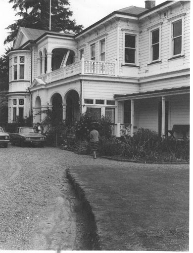 Looking along front of 2-storey weather-board house