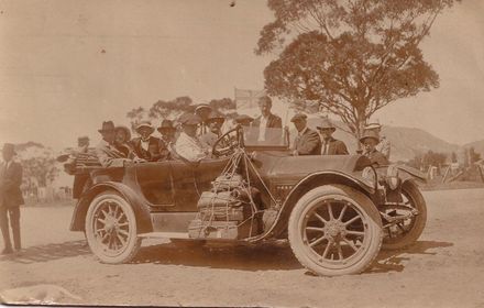 Large group of men with car, 1916
