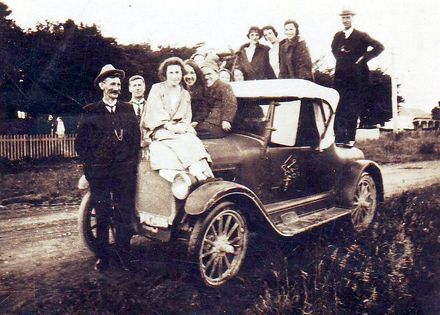 Members of Brown family and others on car, 4 a.m. New Year's morning, 1920's ?