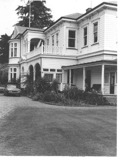 Looking along front of 2-storey weather-board house