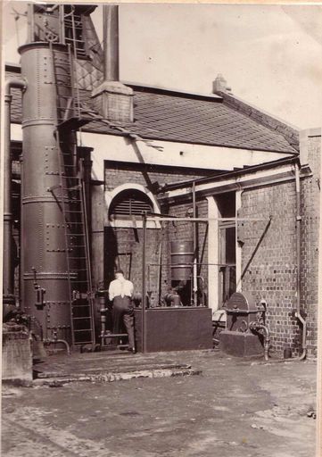 Mr A.C Kennerley working beside exhauster pump