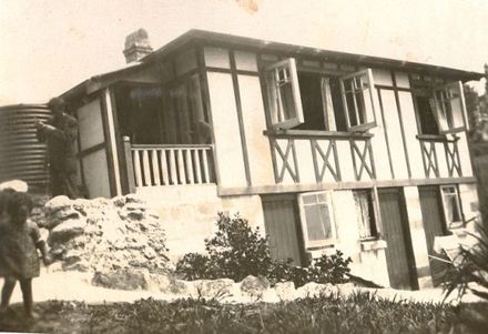 House with a small child in foreground. - Resource cover image
