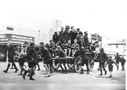 Children pulling waggon loaded with children