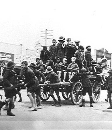 Children pulling waggon loaded with children