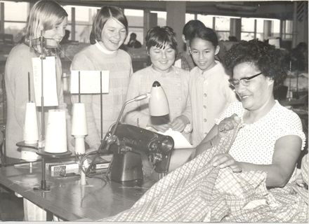 Girls watching sewing machinist at factory - Resource cover image