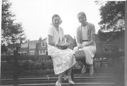 2 ladies sitting on a railing.  Westcliff