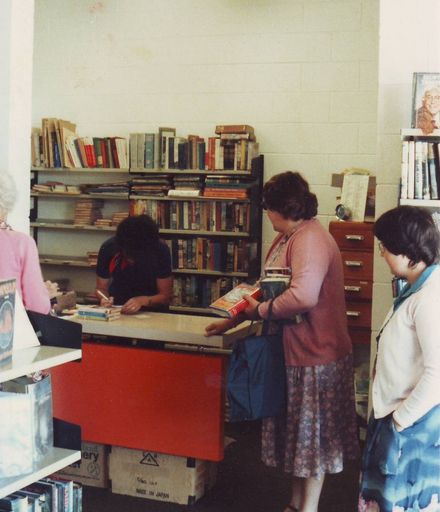 Librarian Mrs Pam Locke issuing books to Mrs Joan Mark, 1981
