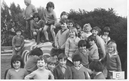Children grouped on old tractor in playground